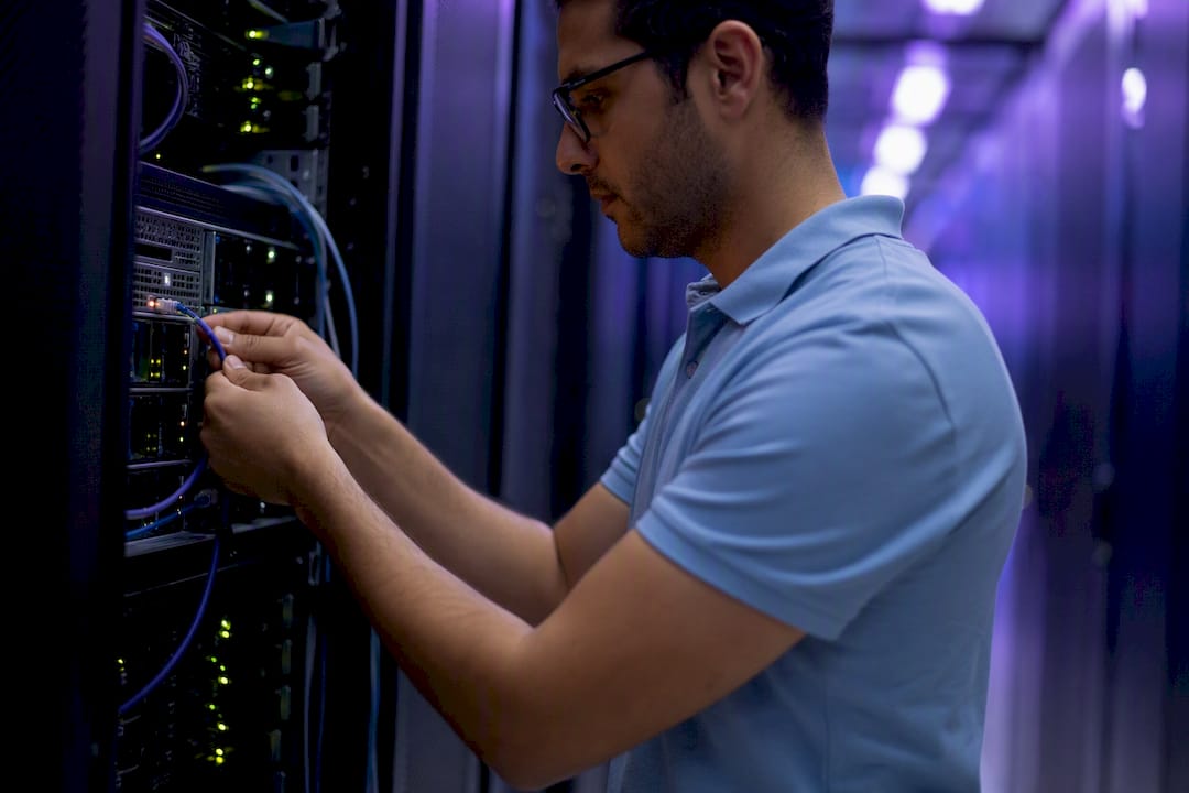 Technician unplugging cloud network cable