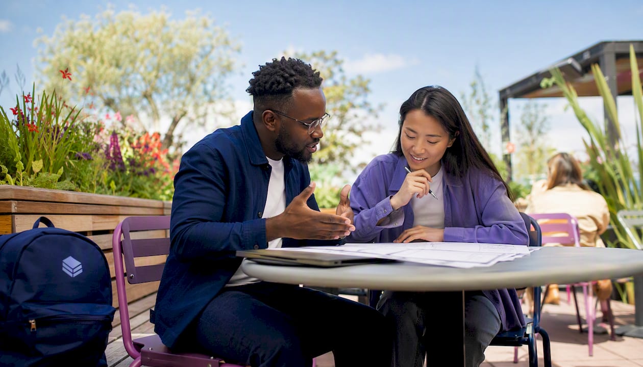 Two engineers discussing cloud automation in office