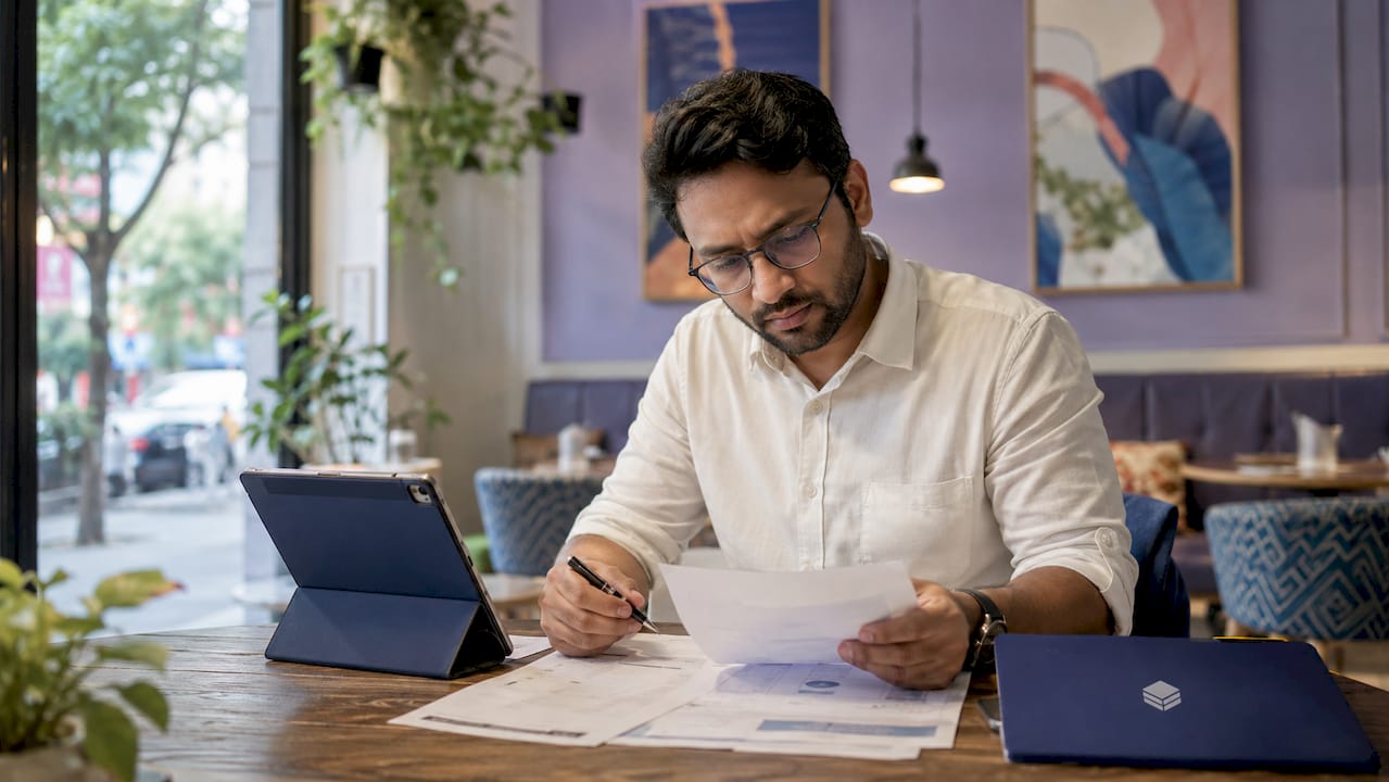 Man reviewing cloud billing documents at desk