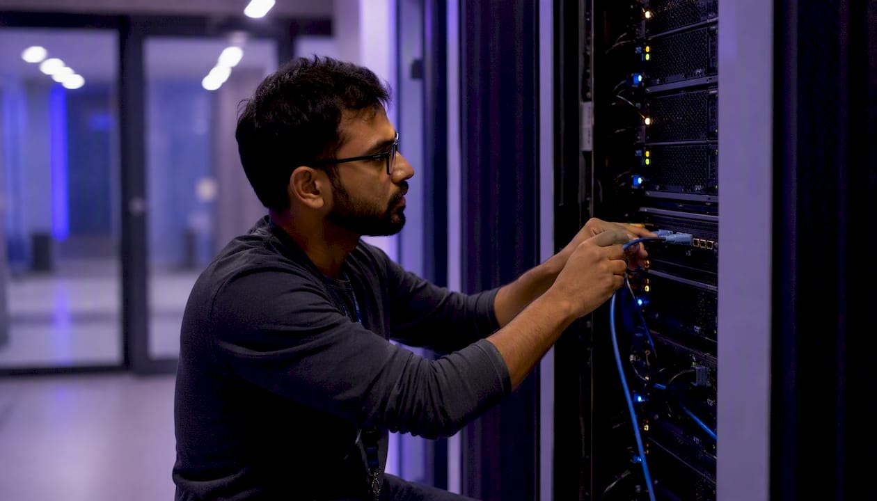 Engineer connecting cable in cloud data center