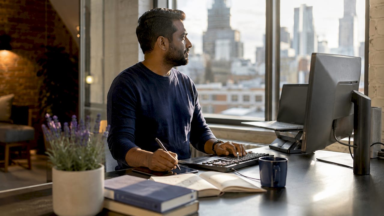Cloud engineer at standing desk working on observability