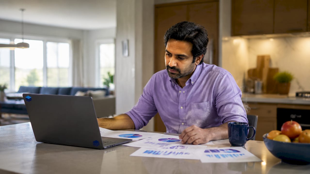 Engineer reviewing cloud resource charts at home desk