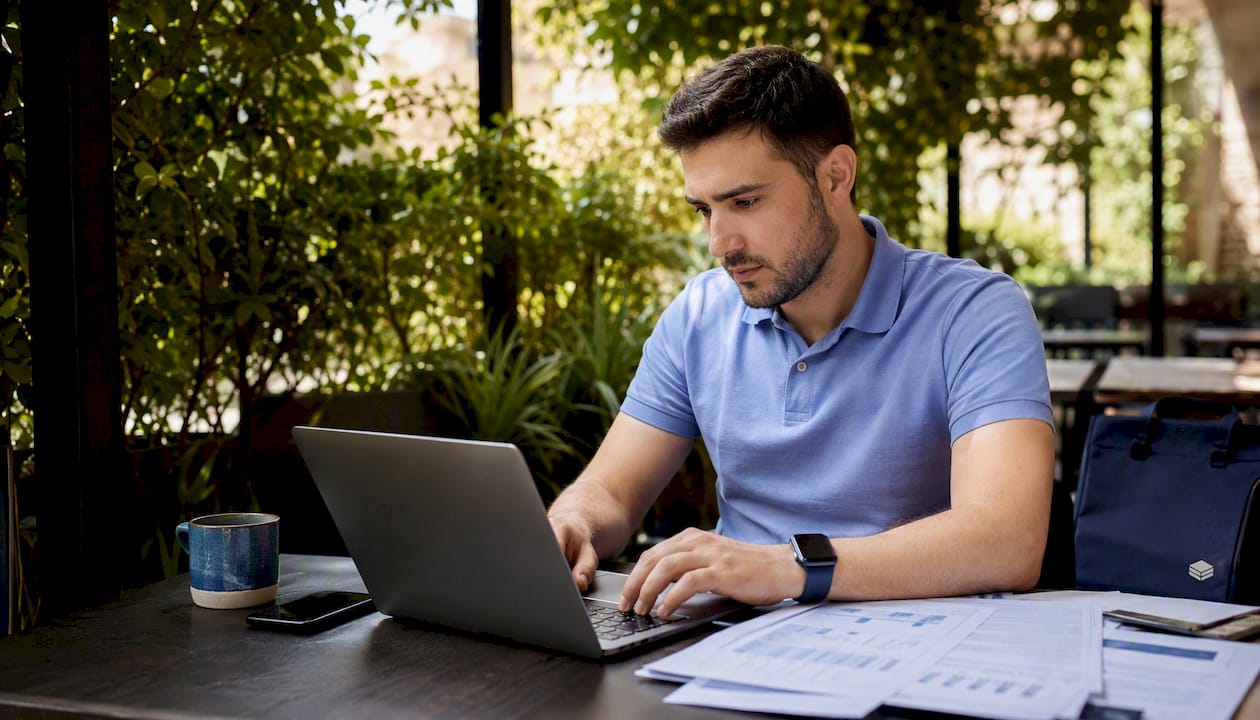 Overhead view of man reviewing cloud spend spreadsheet