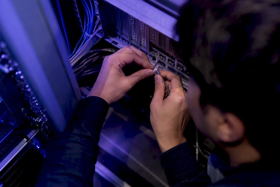 Engineer adjusting network cable in data center