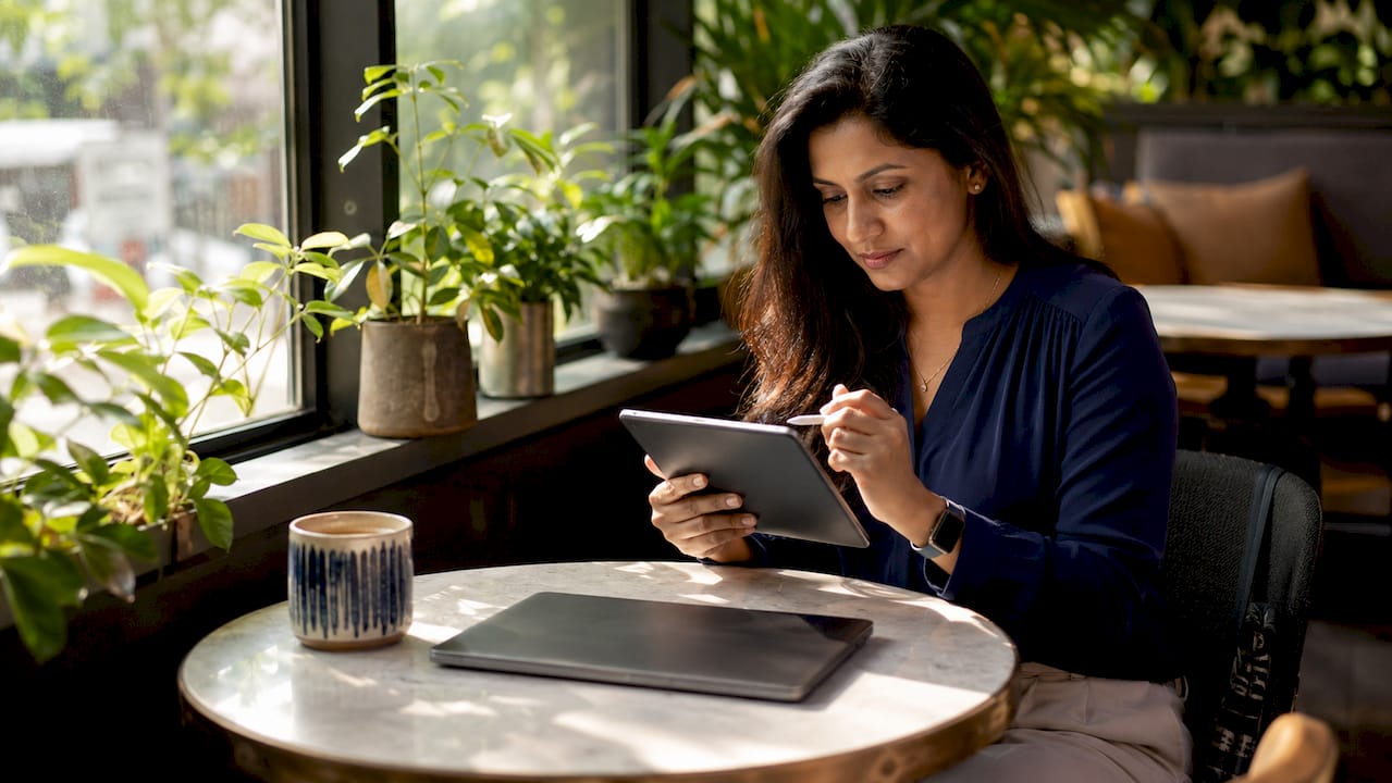 Woman working on tablet in home office