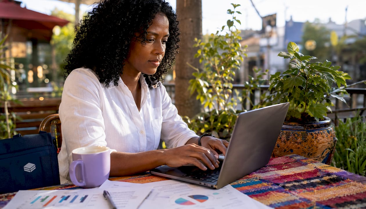 Hands typing at home office with tech setup
