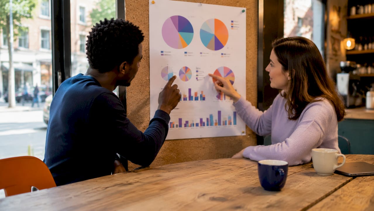 Hands pointing at cloud cost charts in meeting