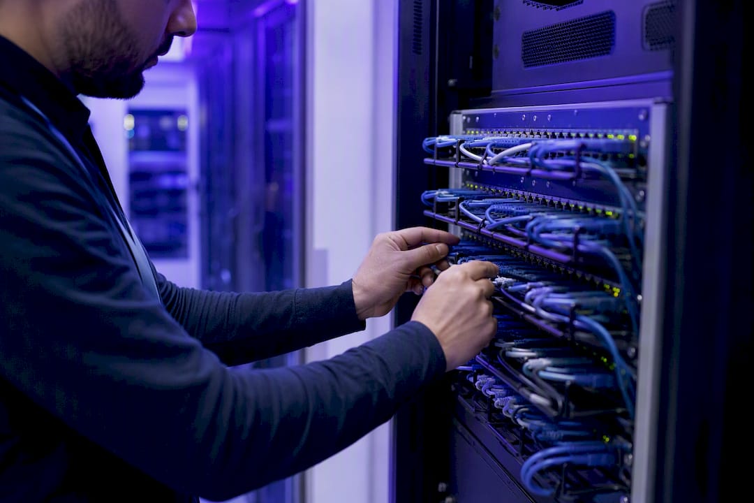 Hands adjusting cloud data center cables